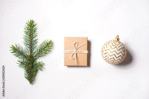 Wallpaper Mural Christmas composition of a branch of fir, a gift and a golden ball on a white background. Flat lay, top view. Torontodigital.ca