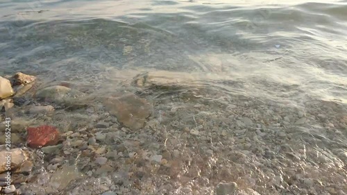 Sea surf on a pebble beach photo