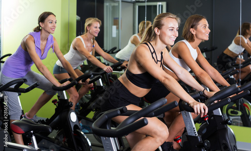 Women cycling in fitness center
