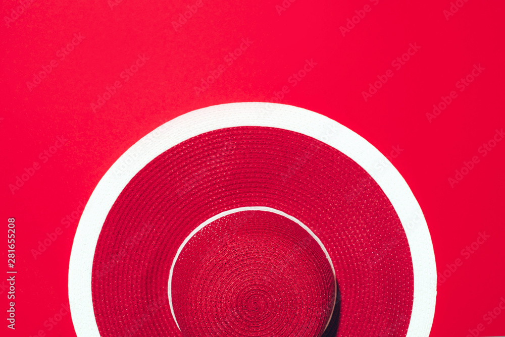 Top view of red striped retro hat over paper background with copy space. Summer travel and holiday concept Top view of red striped retro hat over paper background with copy space. Summer travel and holiday concept