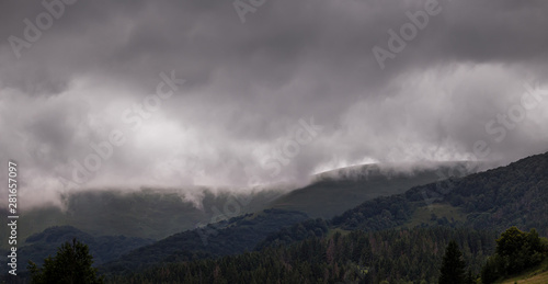 Heavy stormy clouds over green mountain slopes at Carpathian mountains. Ukraine.