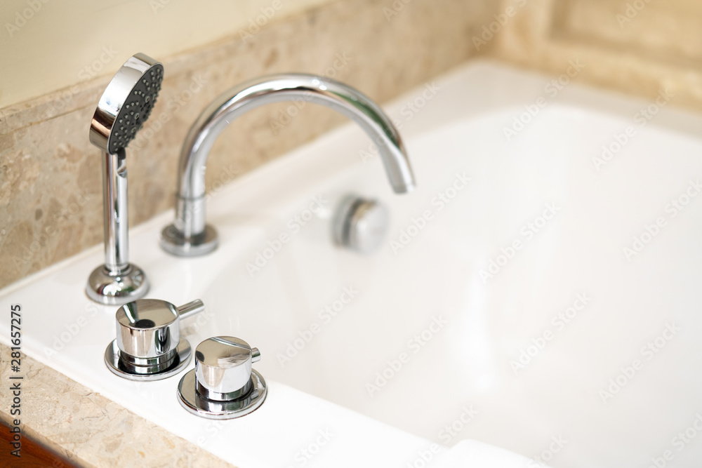 Asia hotel classic luxury bath, bath tub and faucet on white ceramic in a retro style. Modern style chrome bathroom tap in white room. Asia hotel classic luxury bath, bath tub and faucet on white ceramic in a retro style. Modern style chrome bathroom tap in white room.