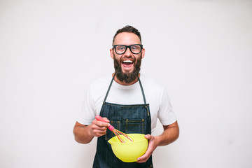 Portrait of a happy young crazy chef cook isolated on a white background