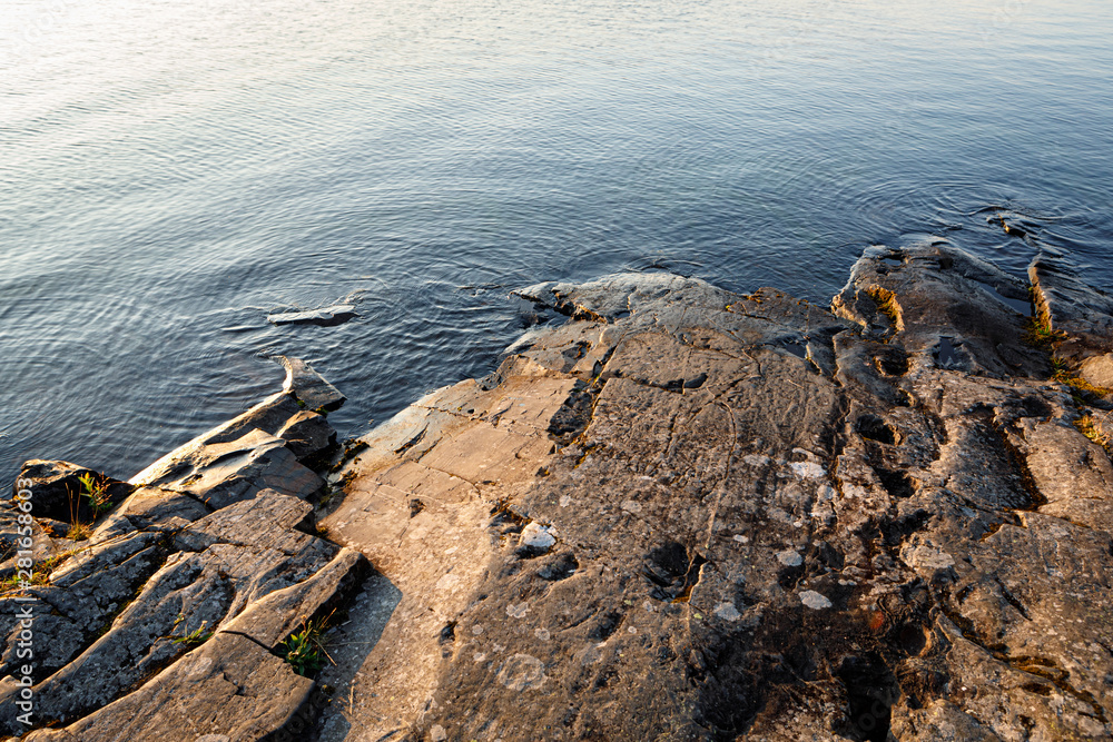 Smooth rock lake shore at dawn