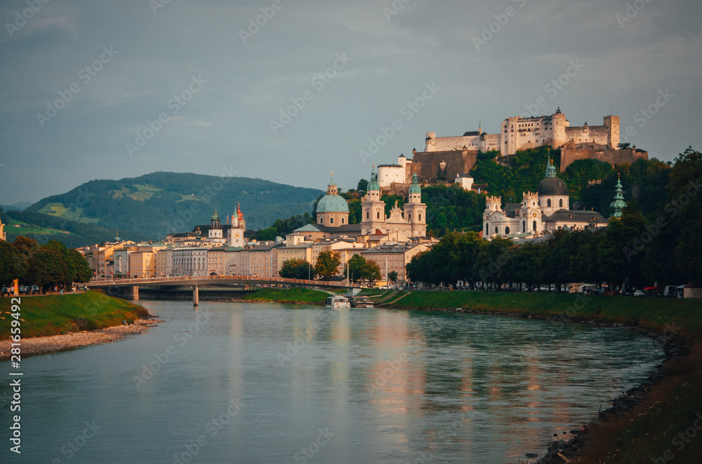 Panoramic view of the historic city of Salzburg with Fortress Hohensalzburg in the background as seen from river Salzach in Salzburg, Austria