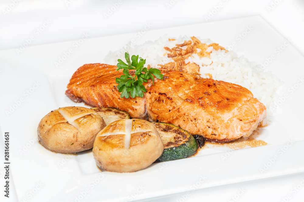 Stir pan fried salmon served with mushroom, zucchini and rice Stir pan fried salmon served with mushroom, zucchini and rice