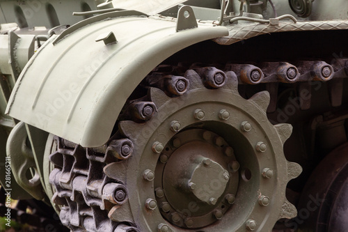 front part of a heavy tracked tank with a wing and a caterpillar with a gear wheel. military conflict concept