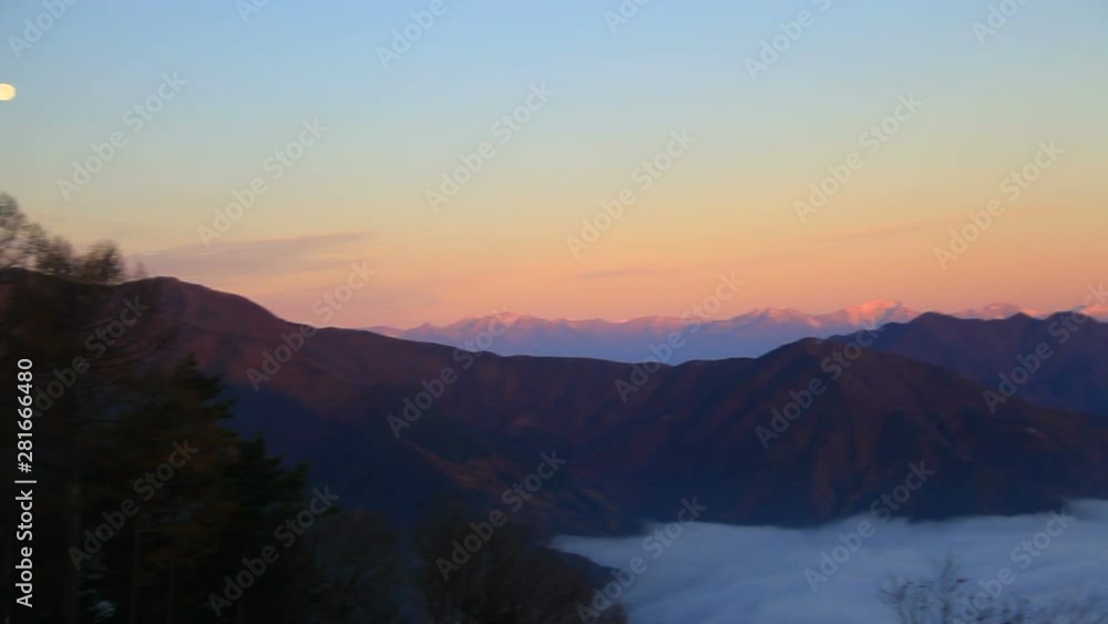 Panning shot of Northern Alps in clouds at sunrise, Japan Panning shot of Northern Alps in clouds at sunrise, Japan