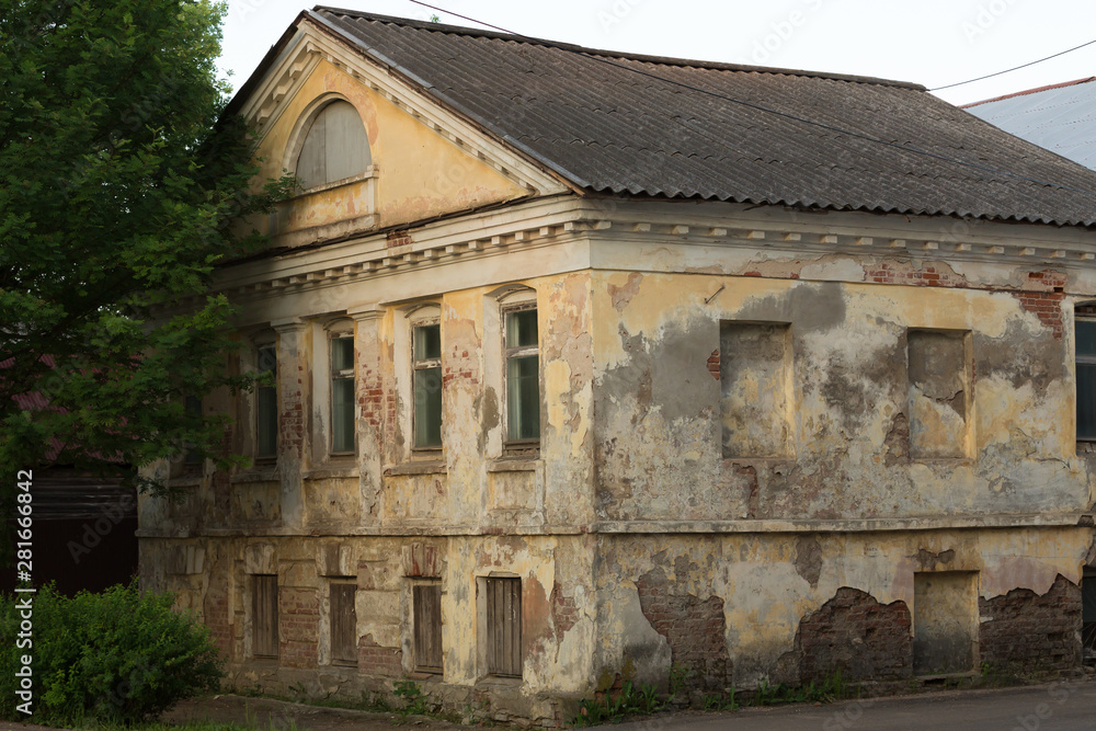 old stone house in russian provincial town at sunset concept of dying small russian towns