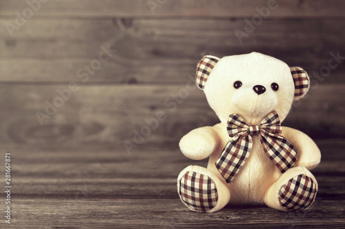 Teddy bear on wooden background with copy space