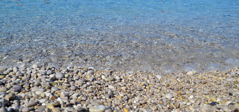 Abstract beach background texture with pebbles, sands and sea water in bodrum turkey Abstract beach background texture with pebbles, sands and sea water in bodrum turkey