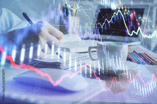 Financial chart drawn over hands taking notes background. Concept of research. Double exposure