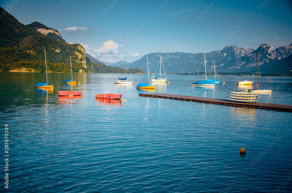 Boats and ships on beautiful blue lake in mountains