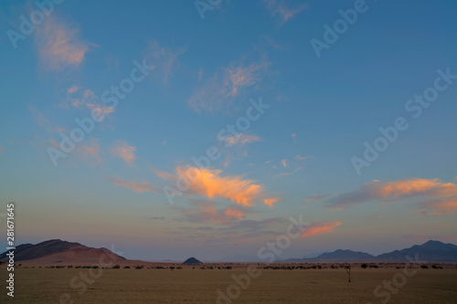 Pink clouds in early morning light in the desert