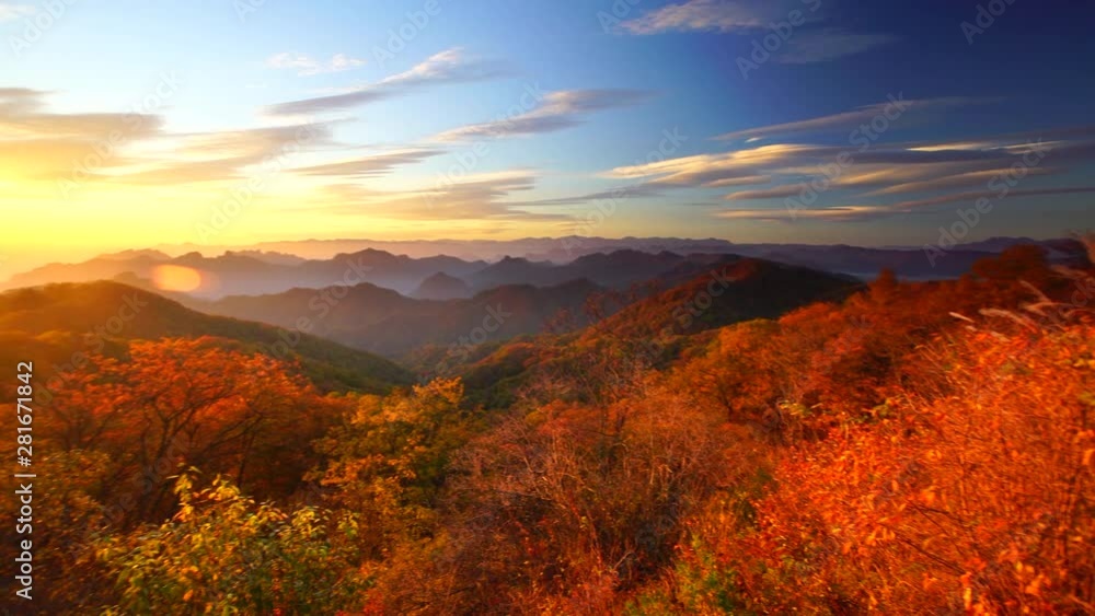 Panning wide shot of mountain landscape at sunrise in fall Panning wide shot of mountain landscape at sunrise in fall