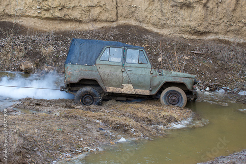 Rally on Russian SUVs in the mud in winter, Trapped all-terrain vehicle pulled out of the river  © Mountains Hunter