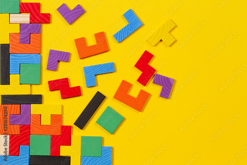 Different colorful shapes wooden blocks on yellow background. Top view Different colorful shapes wooden blocks on yellow background. Top view