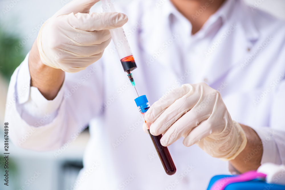 Young lab assistant testing blood samples in hospital Young lab assistant testing blood samples in hospital