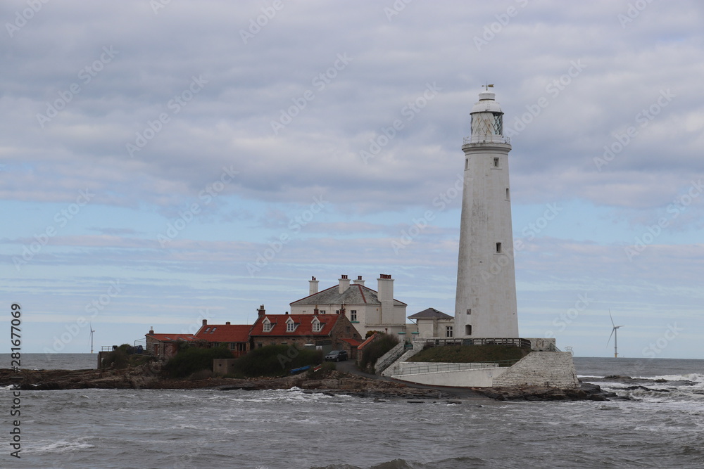 Large white lighthouse on an island 