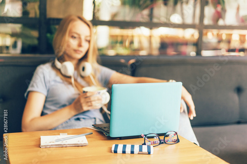 girl in headphones relaxedly looking at a laptop