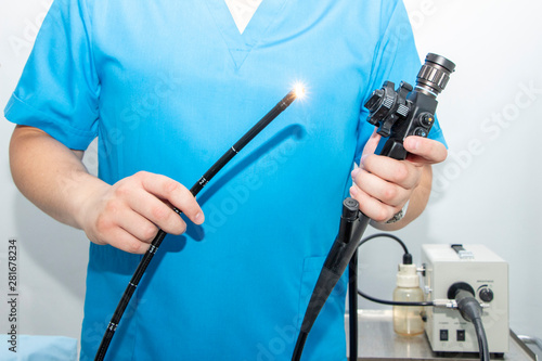 Endoscopy at the hospital. Doctor holding endoscope before gastroscopy. Instrument for endoscopy in the doctor's hands. photo