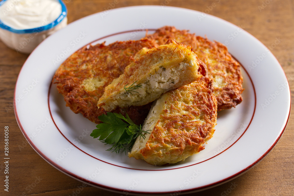 Potato Pancakes Filled With Cheese. Vegetable fritters stuffed with cottage cheese Potato Pancakes Filled With Cheese. Vegetable fritters stuffed with cottage cheese