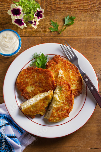 Potato Pancakes Filled With Cheese. Vegetable fritters stuffed with cottage cheese. View from above, top studio shot