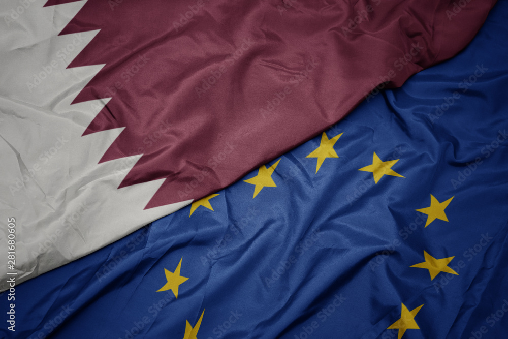 waving colorful flag of european union and flag of qatar. waving colorful flag of european union and flag of qatar.