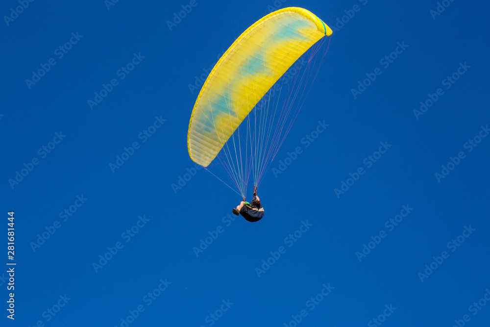 paraglider flying in the blue sky. Paragliding paraglider flying in the blue sky. Paragliding