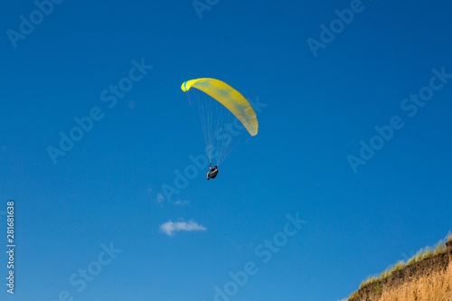 paraglider flying in the blue sky. Paragliding