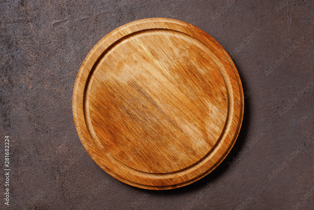 Brown textured background with empty pizza board Brown textured background with empty pizza board