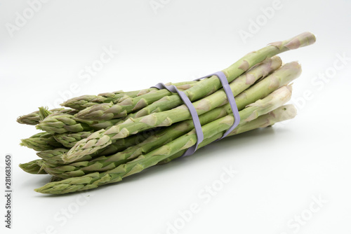 Asparagus surrounded by a medical tape on weighing scale for diets