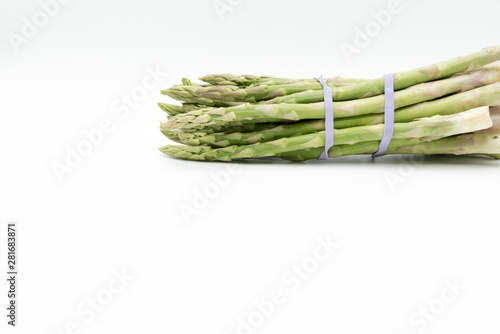 Asparagus surrounded by a medical tape on weighing scale for diets