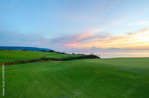 Sunset on a green golf course