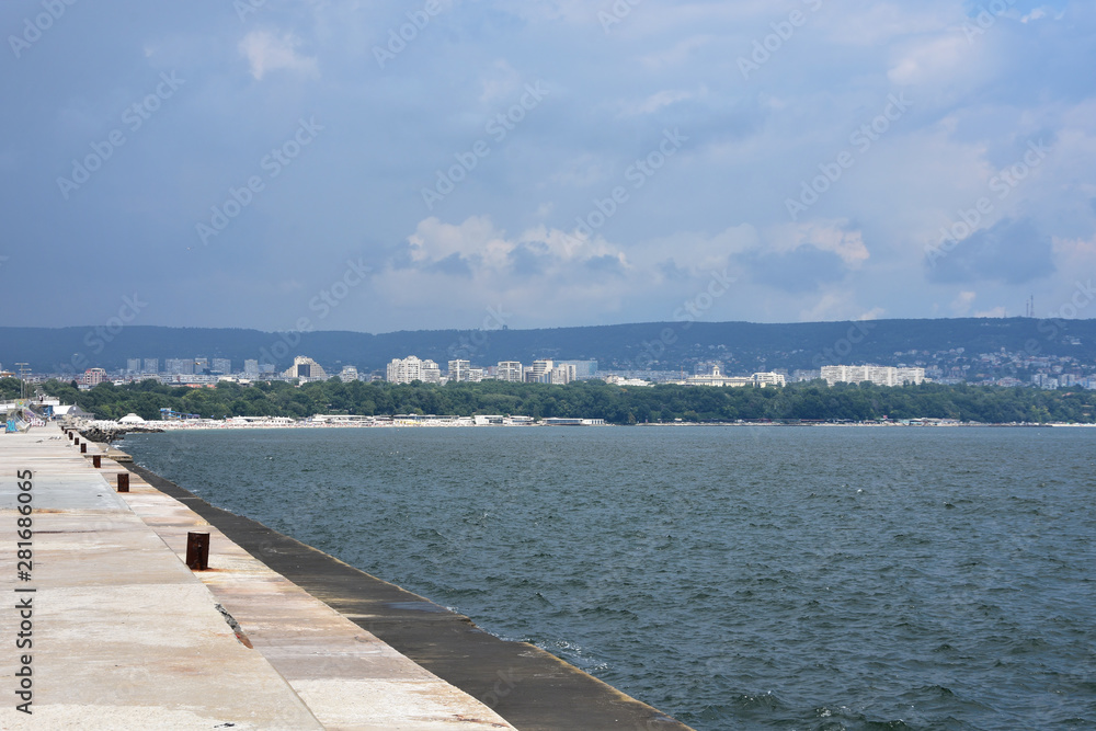 View to the town of Varna from Varna harbour breakwater in a cloudy summer day