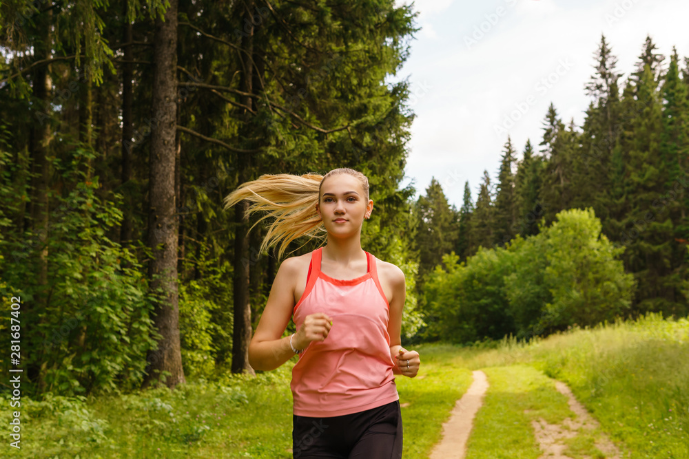 young woman jogging in the forest young woman jogging in the forest