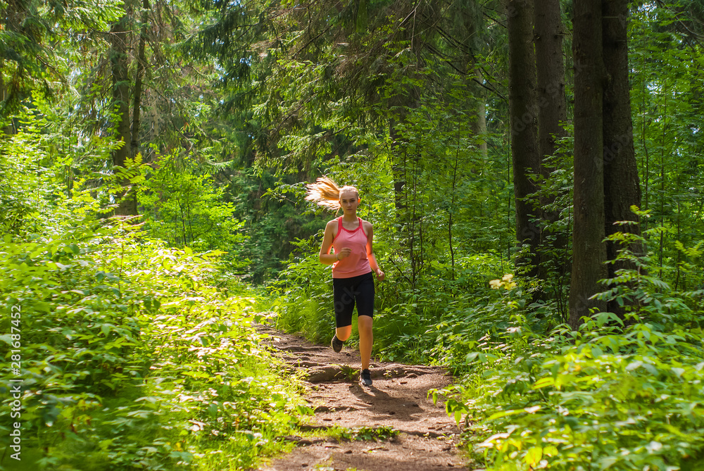 young woman jogging in a mountain forest young woman jogging in a mountain forest