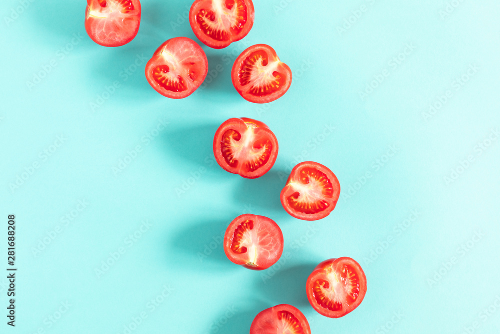 Tomato pattern. Frame made of fresh half tomatoes on light blue background. Flat lay, top view, copy space Tomato pattern. Frame made of fresh half tomatoes on light blue background. Flat lay, top view, copy space
