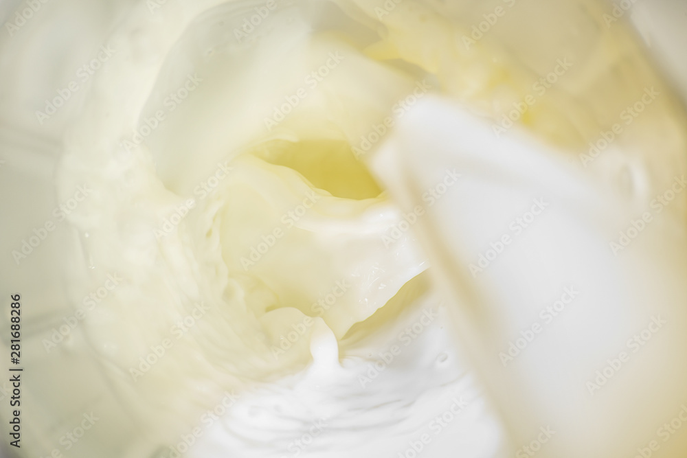 Soft pouring stream of milk is close from above Soft pouring stream of milk is close from above