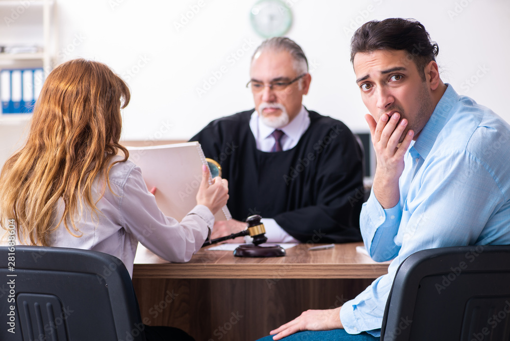 Young couple in the courthouse in divorce concept Young couple in the courthouse in divorce concept