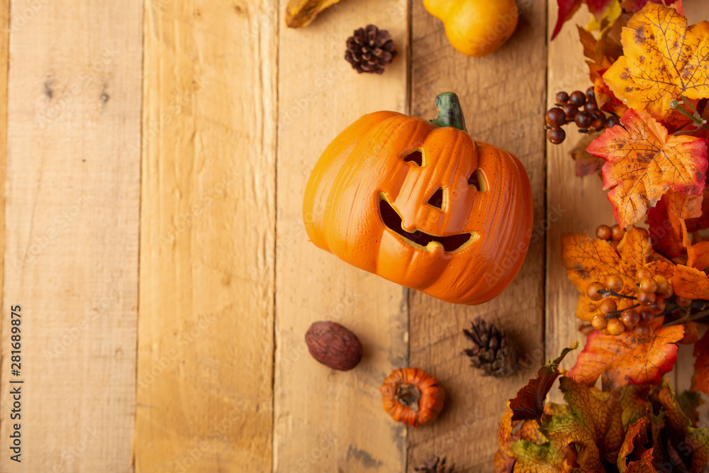 Halloween pumpkin with leaves and pine cones and elements of decor on an old wooden table. View from above. horizontal frame, with space, autumn mood Halloween pumpkin with leaves and pine cones and elements of decor on an old wooden table. View from above. horizontal frame, with space, autumn mood