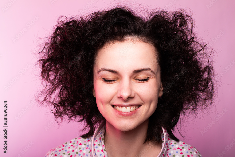beautiful curly girl in pajamas, pink background beautiful curly girl in pajamas, pink background