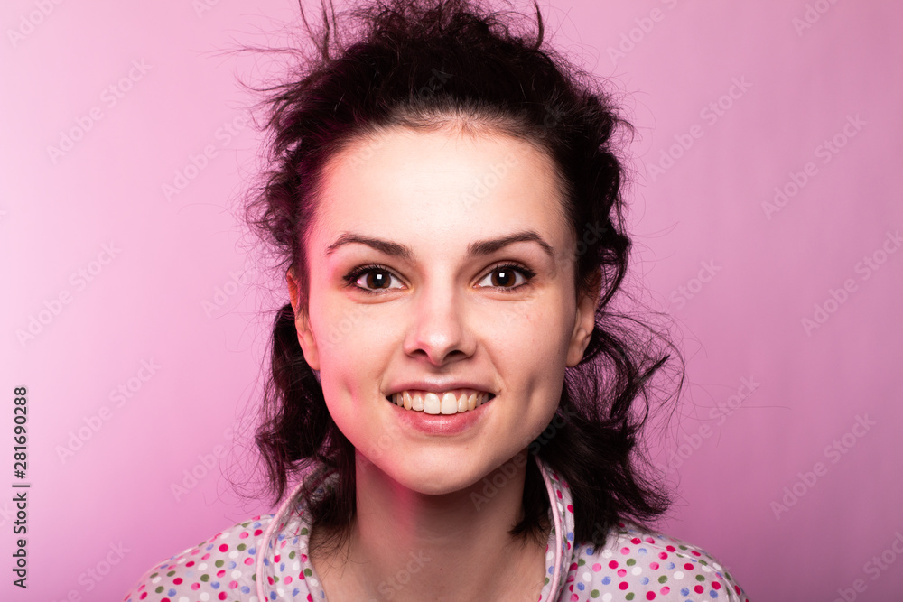 beautiful curly girl in pajamas, pink background beautiful curly girl in pajamas, pink background