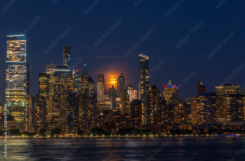 Full Moon Over Manhattan Skyline at night