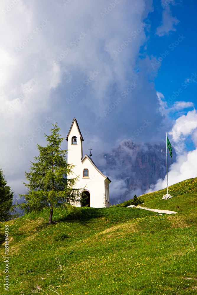 San Maurizio chapel on the passo di val Gardena with mountain view in background. Colorful view in pass Sella in summer sunny day . Alps, Dolomites, Groeden, Bolzano, Trentino Alto Adige, Italy