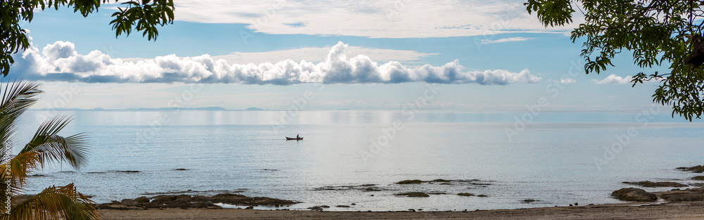 Fishermen boat silhouette against sunrise on Lake Malawi, the sun glitter on the Lake, South-East-Africa