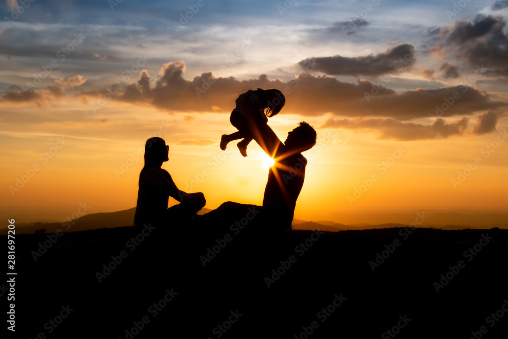 mother, Father and daughter at sunset