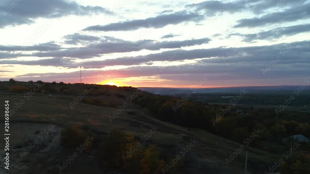 A valley leading towards a village filmed from a side during sunset. A valley leading towards a village filmed from a side during sunset.
