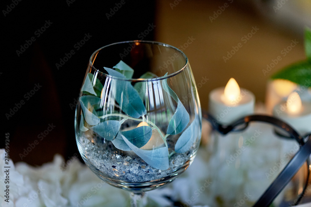 Led candles burning inside a transparent glass goblet. Blue gamma in the design. Led candles burning inside a transparent glass goblet. Blue gamma in the design.