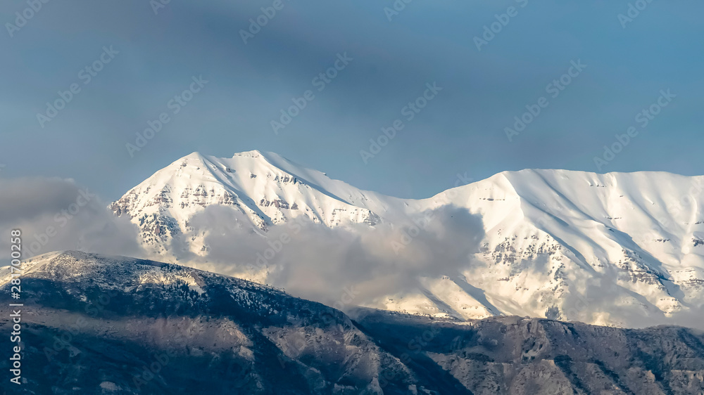 Panorama frame Beautiful view of a mountain with its peak covered with sunlit white snow
